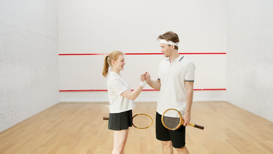 Two squash players engaged in an intense match, showcasing the intensity and skill of professional squash players.