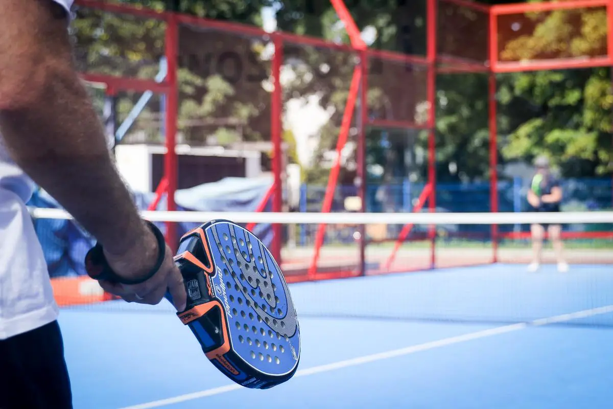 A diverse group of people playing padel, showcasing the inclusivity and community aspect of the sport.