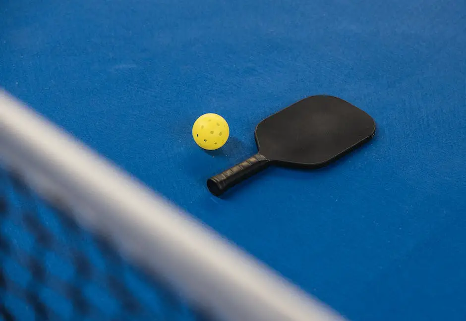 A person holding a pickleball paddle, ready to play in a tournament.
