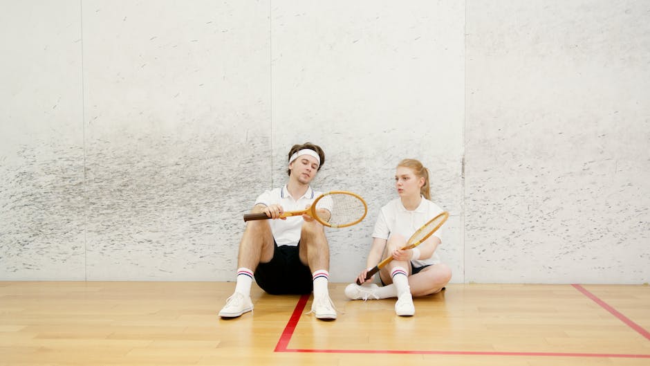 A person performing agility drills on a squash court, improving their skills and fitness.