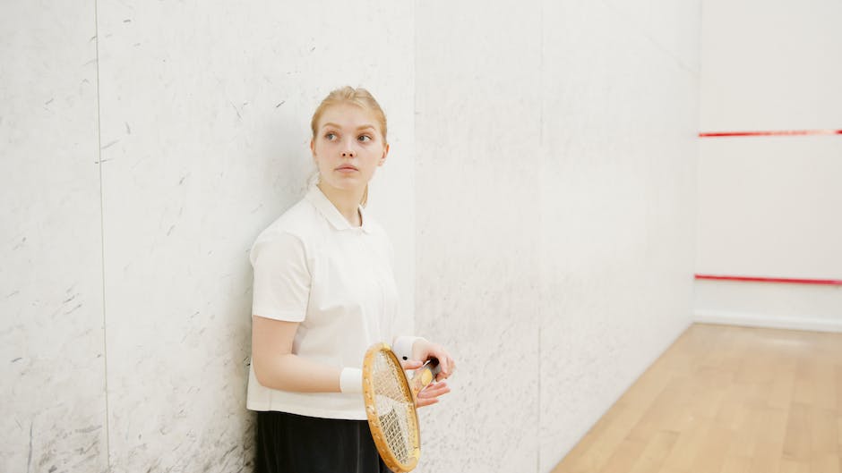 A person playing squash on a court