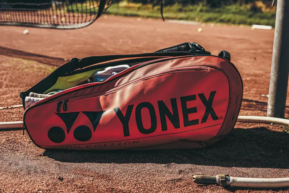 A tennis bag with multiple compartments, holding tennis racquet, balls, towel, water bottle, and other necessary items.