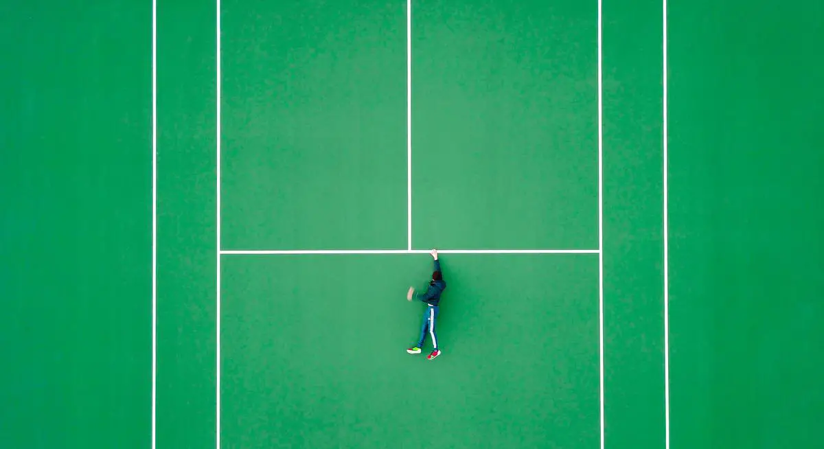 A group of tennis players practicing singles strategies on a sunny court