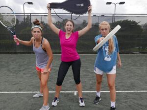 Women posing with their tennis rackets